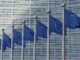 Flags of the European Union as the first regulations from the EU AI Act come into force with policies that set strict rules on how businesses use the technology for their operations and severe penalties for failures.